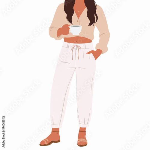 A young woman enjoying a cup of coffee while standing relaxed in casual wear