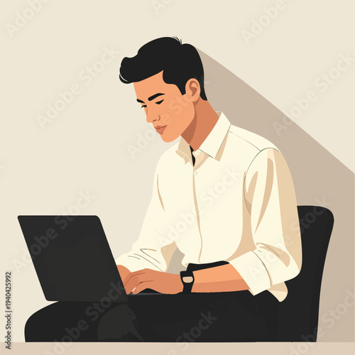 Man working on laptop while sitting on a chair in an office environment viewed from the side