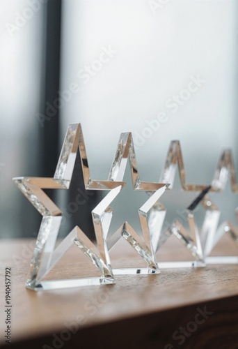 Crystal star awards lined on a wooden surface with soft focus background, concept for corporate recognition, business achievement and successful career milestone