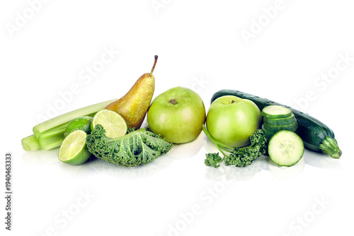 Assortment of Green Fruits and Vegetables Including Kale, Apples, Pears, Limes and Cucumber on White Background