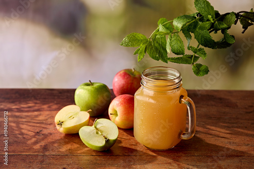 Fresh Apple Juice in Jam Jar Glass with Apples and Mint on Dark Wooden Surface