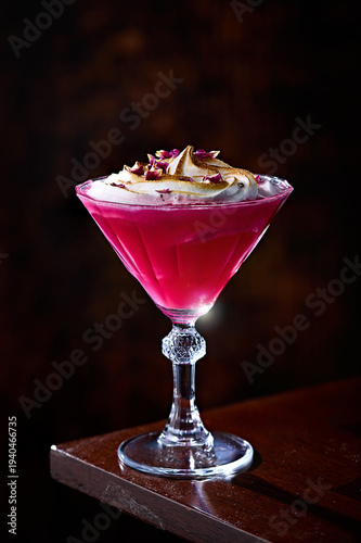Pink Rhubarb Cocktail with Toasted Meringue and Rose Petals in Martini Glass