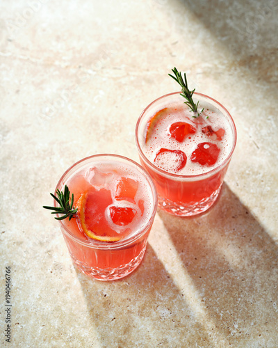 Refreshing Orange Summer Cocktail with Rosemary Garnish in Rocks Glass