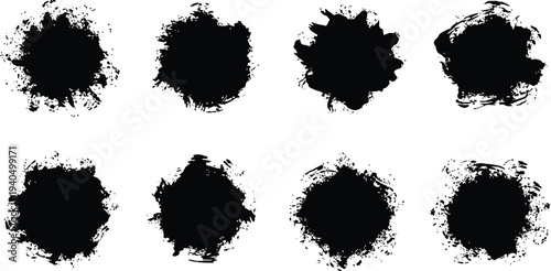 A collection of eight black inkblots on a white background