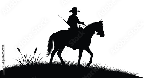 Cowboy riding a horse across a grassy field dark silhouette