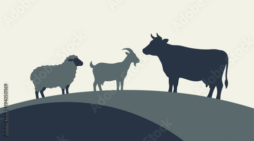 Farm animals standing together on a hilltop landscape viewed from the side