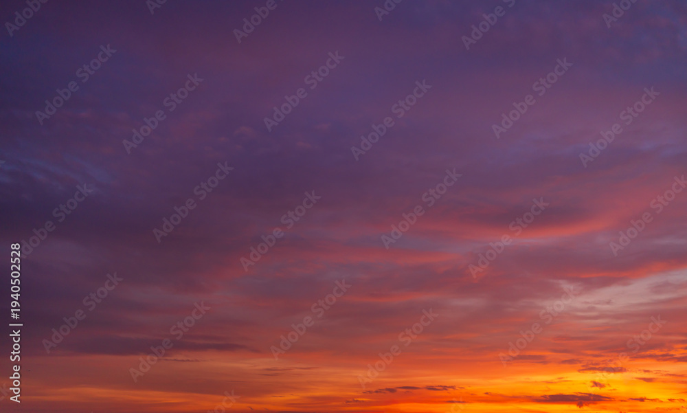 Fototapeta premium Stunning purple and orange sunset sky with altocumulus clouds,Beautiful dramatic sunset sky with vibrant purple and pink altocumulus clouds over a soft golden horizon. Perfect for nature backgrounds, 