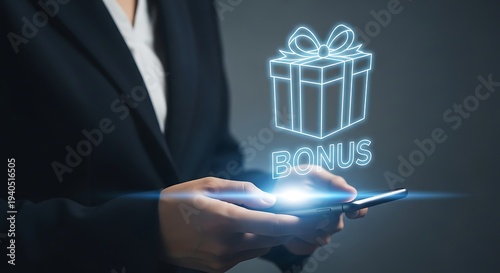 Business professional holding a mobile phone with a digital bonus gift box and ribbon displayed above the screen symbolizing reward and incentive.