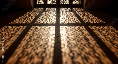 Close-up of ornate metal floor tiles with sunlight shining through, golden decorative patterns