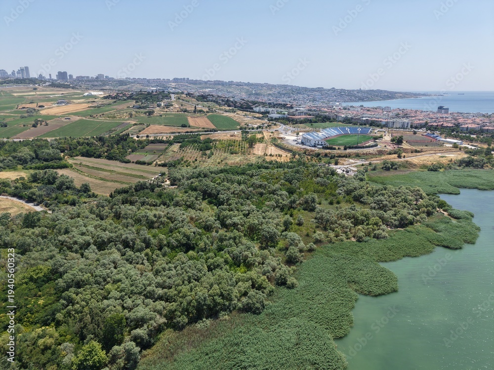 Obraz premium High Altitude Aerial Drone View of Curved Coastal Bay, Seaside Residential District and Scenic Marmara Sea Shoreline in Turkey on a Clear Summer Day