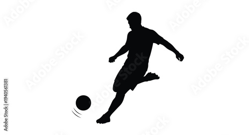 A soccer player kicks the ball in dynamic motion silhouette