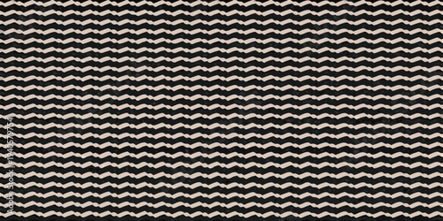 A close up of a black and beige chevron patterned woven textile