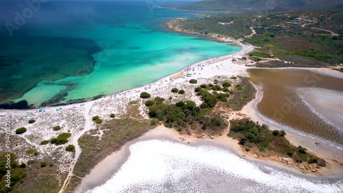 Sardinia Isuledda Beach aerial FPV flight over salt lakes to turquoise sea through low clouds and mist San Teodoro Italy white sand coast drone footage 4k cinematic landscape travel destination