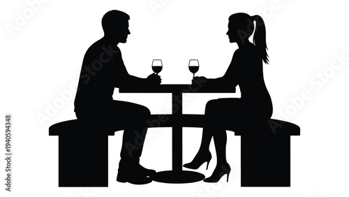 A man and woman sitting at a table with wine glasses