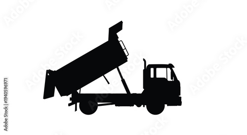 A stark silhouette depicts a heavy duty dump truck with its bed raised suggesting construction or material transport high quality