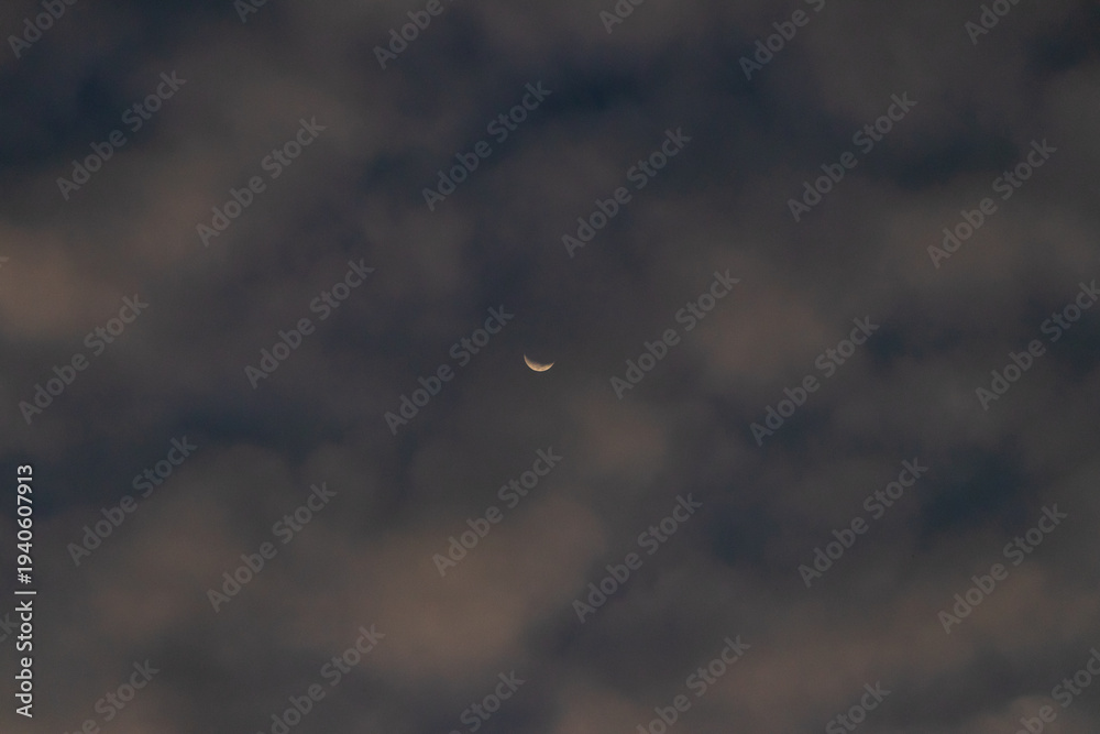 Fototapeta premium Slim crescent moon night sky cloud twilight evening serene crescent moon shining through soft evening clouds with gentle twilight tones creating