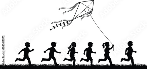Black silhouette of a group of happy children running on grass and flying a large kite against a white background