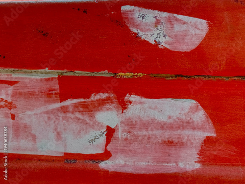 A red and white painting with white paint on the red