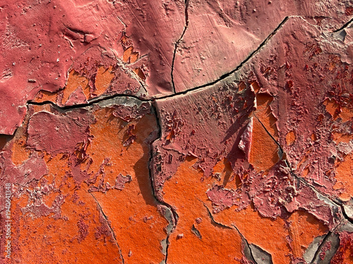 The image is of a wall with a lot of cracks and peeling paint