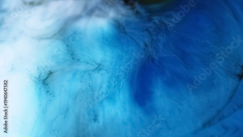 Defocused acrylic paint. Blue spill texture. Vivid water color liquid spatter marble mix spreading on abstract art background.