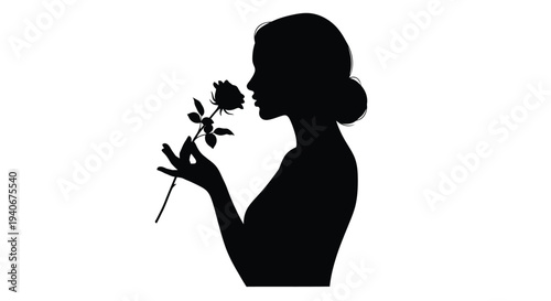 Silhouette of a woman smelling a single rose in profile view