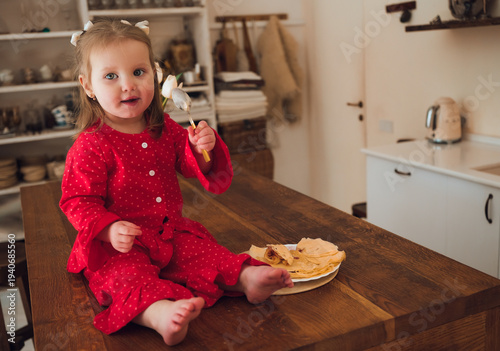 Tableau sur toile Cute Toddler Girl Eating Homemade Pancake During Morning Breakfast At Home