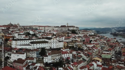 Cinematic aerial drone panorama of Coimbra, Portugal — historic European cityscape with skyline, landmarks and architecture in daylight, a high-angle travel view over urban rooftops