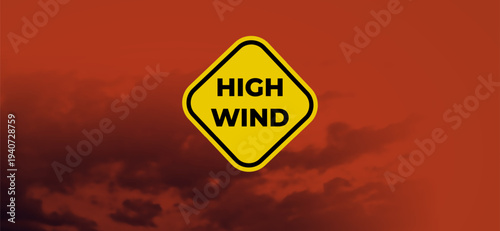 High Wind Watch Warning Yellow Caution Sign Floating Against Dramatic Red Orange Stormy Sky