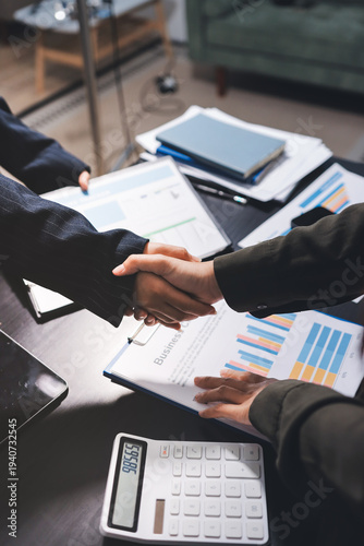 Young business people shaking hands in the office. Finishing successful meeting. Three persons. Wide screen panoramic