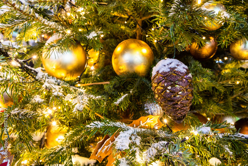 Photography balls and cone on snow-covered christmas tree