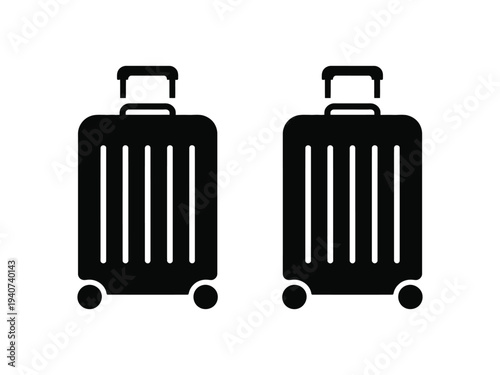Two black rolling suitcases sit ready for.