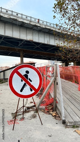 No walking sign. Repairs under the bridge.