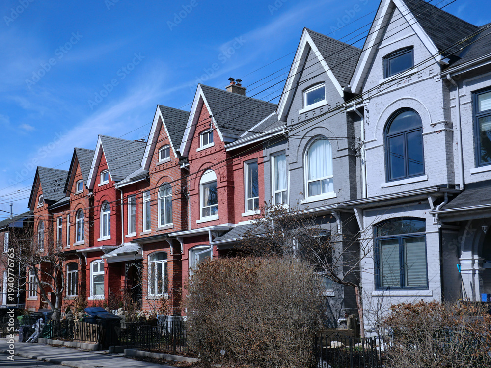 Obraz premium Row of narrow Victorian brick houses with gables