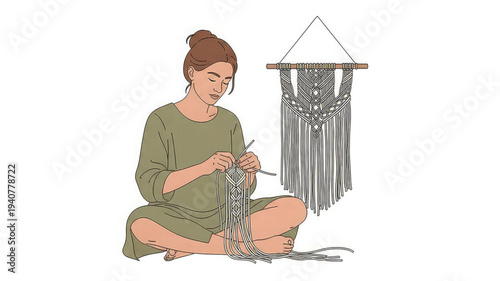 Woman sitting cross legged knitting with yarn and needles next to a macrame wall hanging
