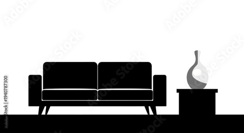 Silhouette of a modern black sofa and side table with a vase