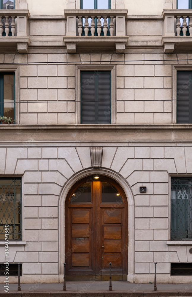 Obraz premium Symmetrical wooden entrance door in historic European building facade