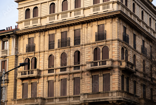 Billede på lærred Elegant historic European building facade with ornate architectural details, balconies and shutters