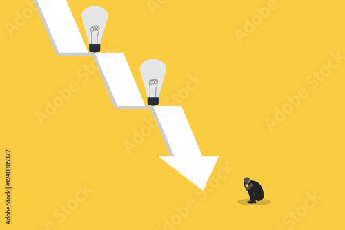 Businessman crouching in despair at a falling downward arrow with lightbulbs, representing innovation failure, economic crisis, and bankruptcy