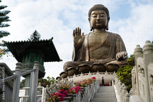 The Tian Tan Buddha at Po Lin Monastery seen from the upper staircase, with a single visitor approaching the base of the statue, Ngong Ping, Lantau Island, Hong Kong