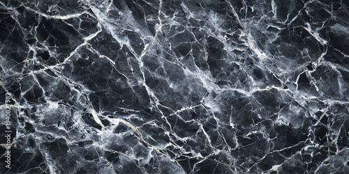 Abstract an impressive dark marble texture with striking white veining patterns, presenting a sophisticated, natural backdrop.