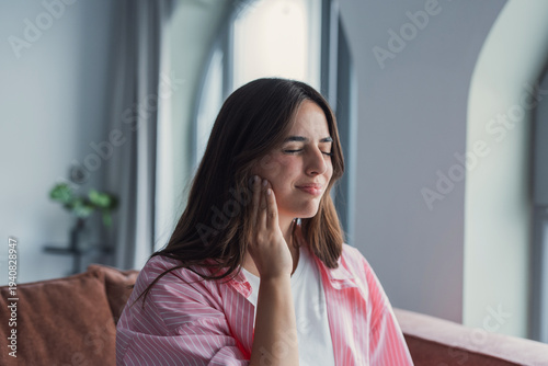Konstfotografi Living room, sofa and woman with mouth in pain for dental inflammation, problem or discomfort of cavity