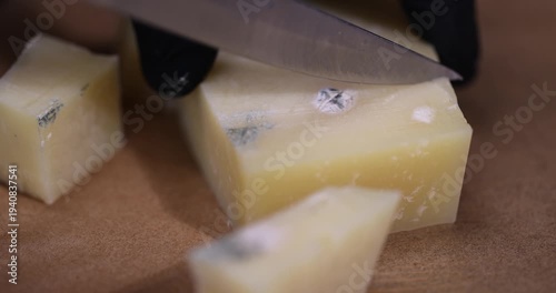 an old spoiled orange cheese with a lot of colorful mold, an inedible and dangerous cheese that was spoiled, close up