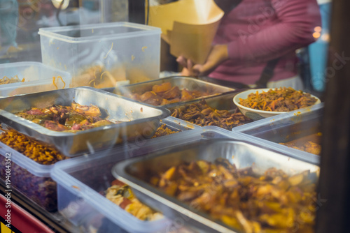 Foto glass display case at a buffet food stall on the side of an Indonesian road
