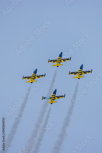 Four L-39 Albatros jets performs with four jets in formation, leaving smoke trails.