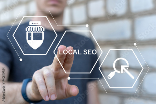 Concept of local seo strategy, local search optimization. Person using virtual touch screen presses the text LOCAL SEO.