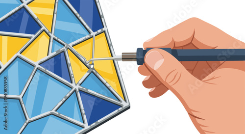 A hand holds a soldering iron, carefully applying solder to a joint on a geometric stained glass piece.