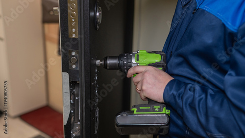 The technician installs a smart electronic lock on the front door.