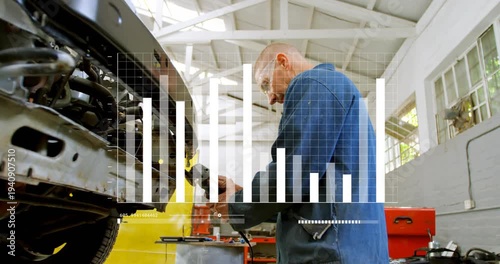 Mechanic inspecting bumper then engaging grinder, producing sparks while repairing car in garage