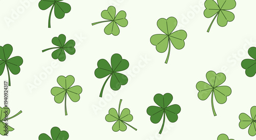 Seamless pattern of green shamrocks on a light green background, with varying shades and sizes of clover leaves.