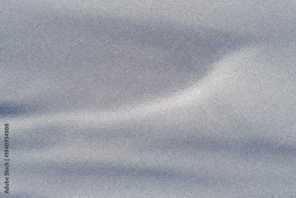 Fototapeta premium Gentle silver-grey waves flow across a fine grain surface, creating a calm abstract background ideal for modern branding, packaging, or minimalist digital designs.